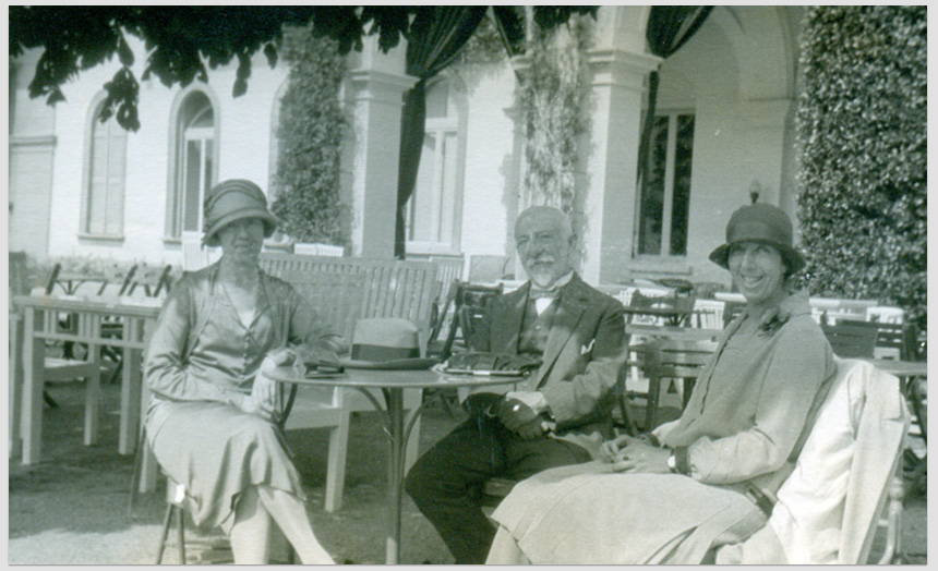 David Edward Theomin with his daughter Dorothy. They are seated at a table with an unidentified woman. This photo forms a black and white postcard, possibly from holiday overseas travel in 1927.