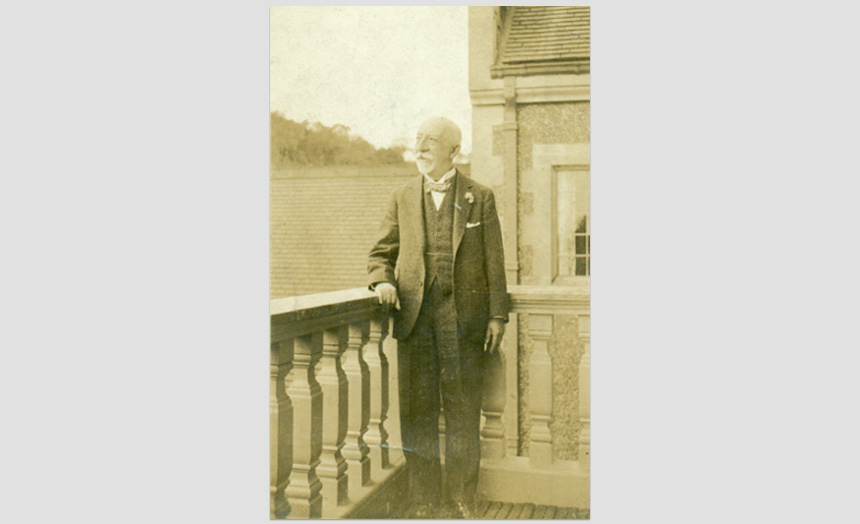 David Theomin, late 70's in age. At Olveston on the balcony off the sitting room. 'S506' Kodak print. (Passed on by Margery Blackman from Mr John F Walker, custodian at Olveston 1967-1971).